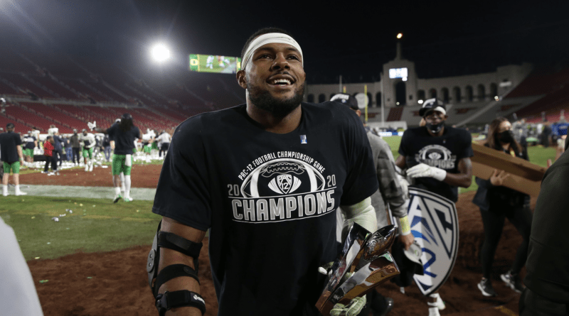 kayvon thibodeaux with mvp trophy