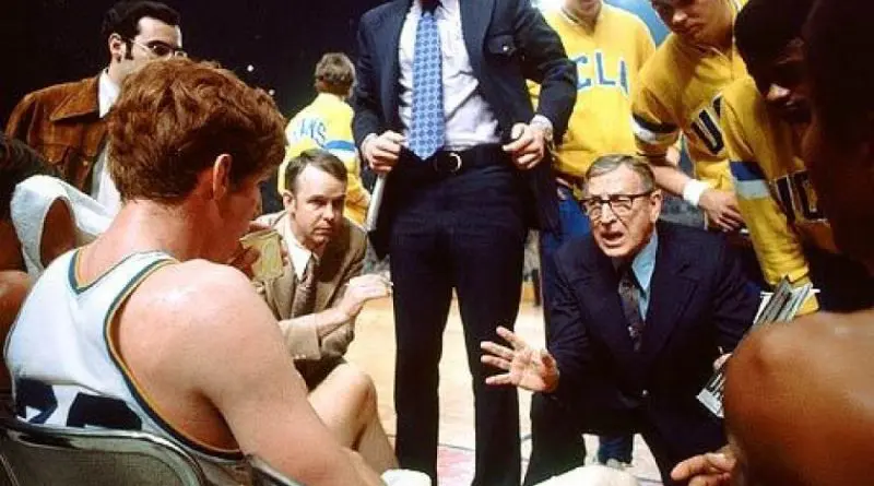 Former UCLA coach John Wooden with Bill Walton and other Bruins during a timeout.