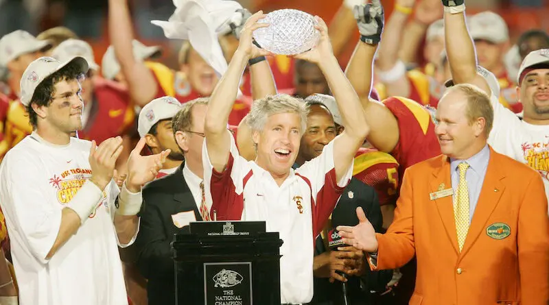 Pete Carroll hoists the national title trophy after his 2004 USC football team defeated Oklahoma in the Orange Bowl