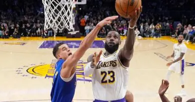 Lakers guard LeBron James drives past Nuggets' Michael Porter Jr. to hit the layup that put him at 40,000 career points | Mark J. Terrill/AP