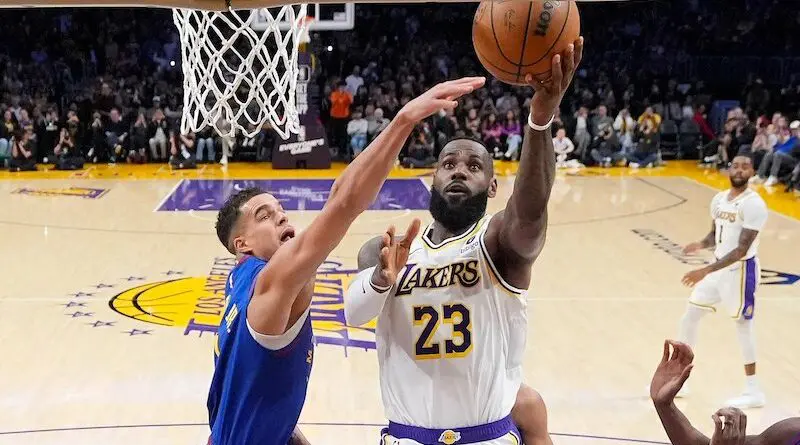 Lakers guard LeBron James drives past Nuggets' Michael Porter Jr. to hit the layup that put him at 40,000 career points | Mark J. Terrill/AP