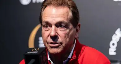 Former Alabama coach Nick Saban in front of a microphone