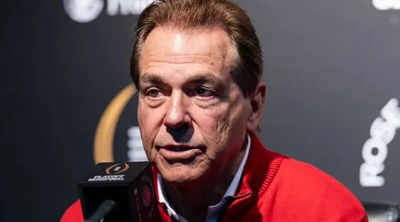 Former Alabama coach Nick Saban in front of a microphone