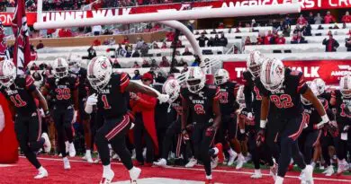 Utah Utes football players running out of the tunnel at Rice-Eccles