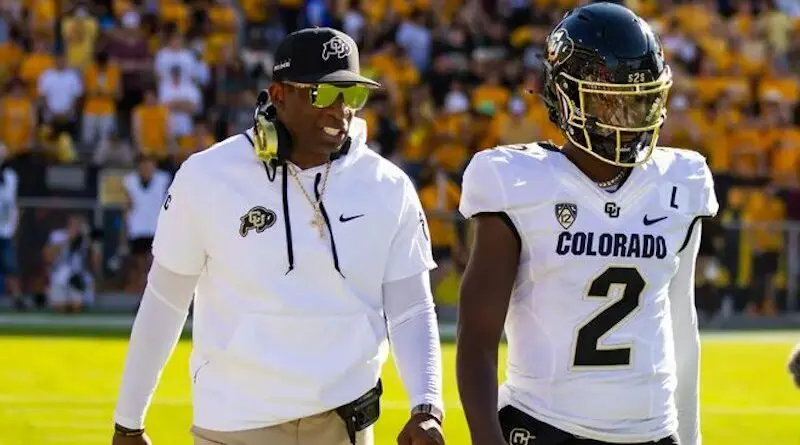 Colorado coach Deion Sanders with his QB-son Shedeur Sanders