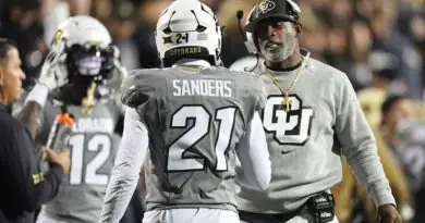 Colorado head coach Deion Sanders, right, confers with his son, safety Shilo Sanders (21), in the first half of an NCAA college football game against Cincinnati, Saturday, Oct. 26, 2024, in Boulder, Colo.
