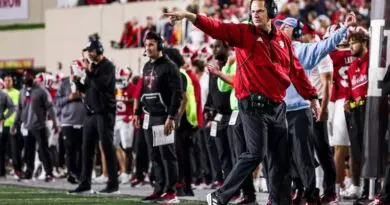 Indiana football coach Curt Cignetti and the Hoosiers running onto the field in 2024