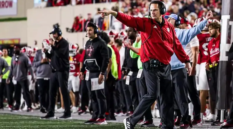 Indiana football coach Curt Cignetti and the Hoosiers running onto the field in 2024