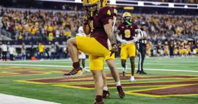 Arizona State's Cam Skattebo srikes a Heisman pose aftrer scoromg
