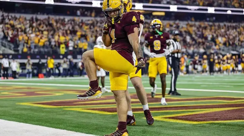 Arizona State's Cam Skattebo srikes a Heisman pose aftrer scoromg