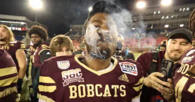 Texas State football players celebrate with cigars.