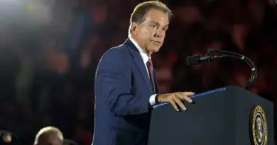 Former Alabama football head coach Nick Saban speaking at the presidential podium.