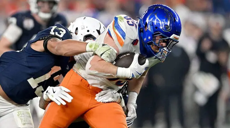 Penn State linebacker Tony Rojas reaches to stop Boise State tight end Matt Lauter during the Fiesta Bowl. Lauter and the Broncos will open the 2025 season on a Thursday night in August.