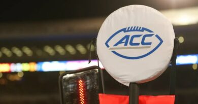 ACC First-Down Markers on the sidelines of a football game.