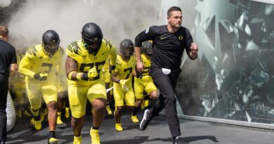 Dan Lanning and his Oregon football team running out of the tunnel.