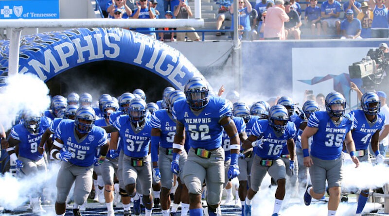 Memphis football players running out of the tunnel