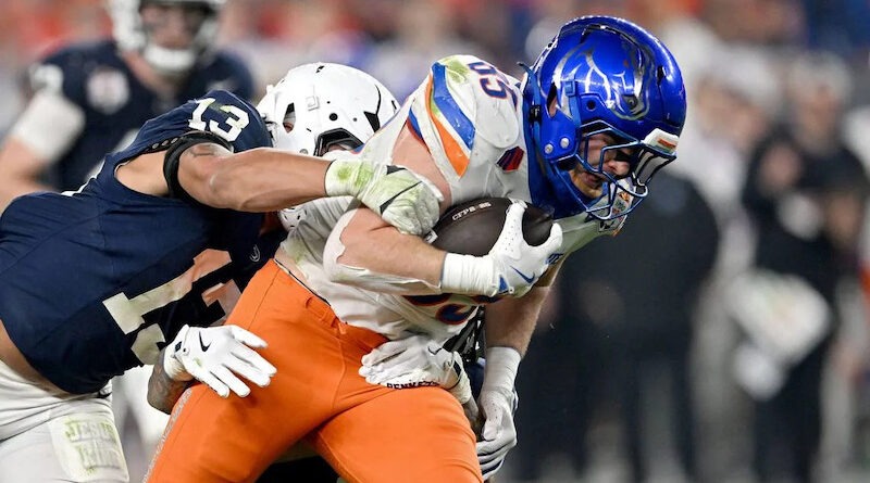 Penn State linebacker Tony Rojas reaches to stop Boise State tight end Matt Lauter during the Fiesta Bowl. Lauter and the Broncos will open the 2025 season on a Thursday night in August.