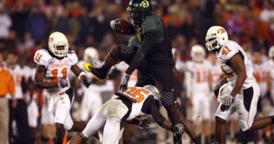 Oregon's LeGarrette Blount hurdles a Cowboy player en route to a touchdown a 42-31 win over Oklahoma State in 2008