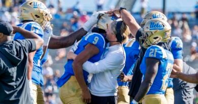 UCLA offensive coordinator Jerry Neuheisel hugs UCLA Bruins quarterback Nico Iamaleava (9) after lamaleava scored a touchdown and threw a 2-point conversion against Penn State in the fourth quarter at the Rose Bowl on October 4, 2025 in Pasadena, California
