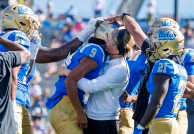 UCLA offensive coordinator Jerry Neuheisel hugs UCLA Bruins quarterback Nico Iamaleava (9) after lamaleava scored a touchdown and threw a 2-point conversion against Penn State in the fourth quarter at the Rose Bowl on October 4, 2025 in Pasadena, California