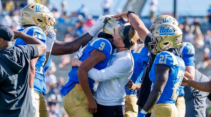 UCLA offensive coordinator Jerry Neuheisel hugs UCLA Bruins quarterback Nico Iamaleava (9) after lamaleava scored a touchdown and threw a 2-point conversion against Penn State in the fourth quarter at the Rose Bowl on October 4, 2025 in Pasadena, California